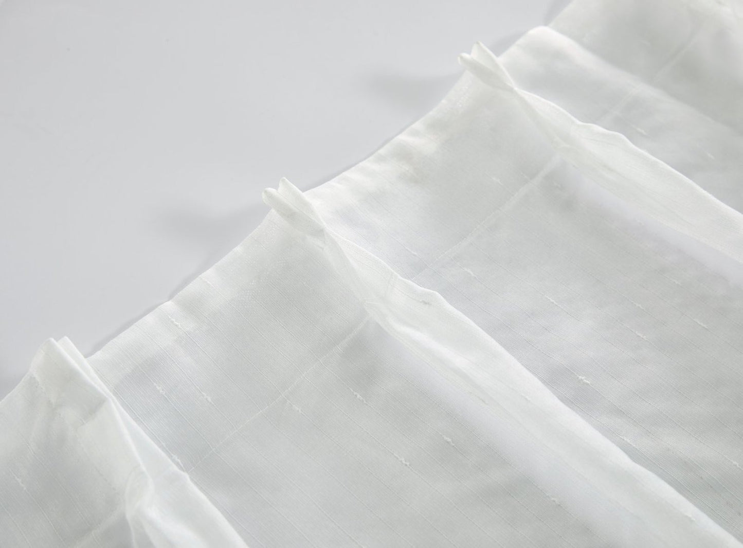White sheer fabric with subtle texture 